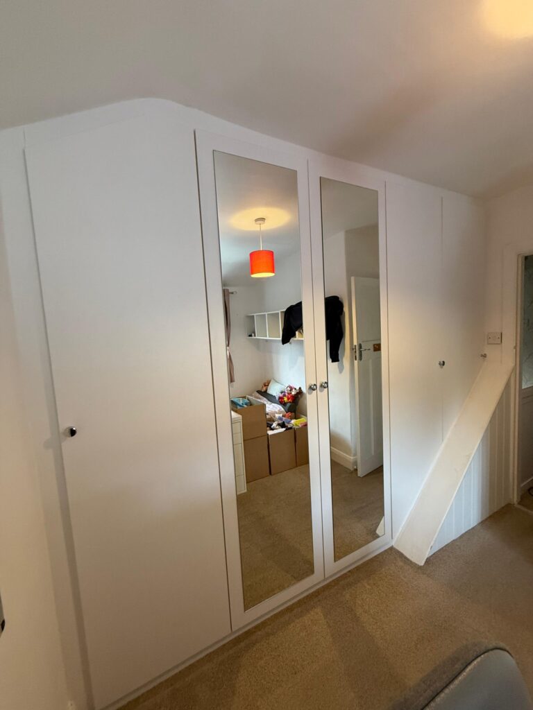 Bespoke fitted angled hinged wardrobe in Kent