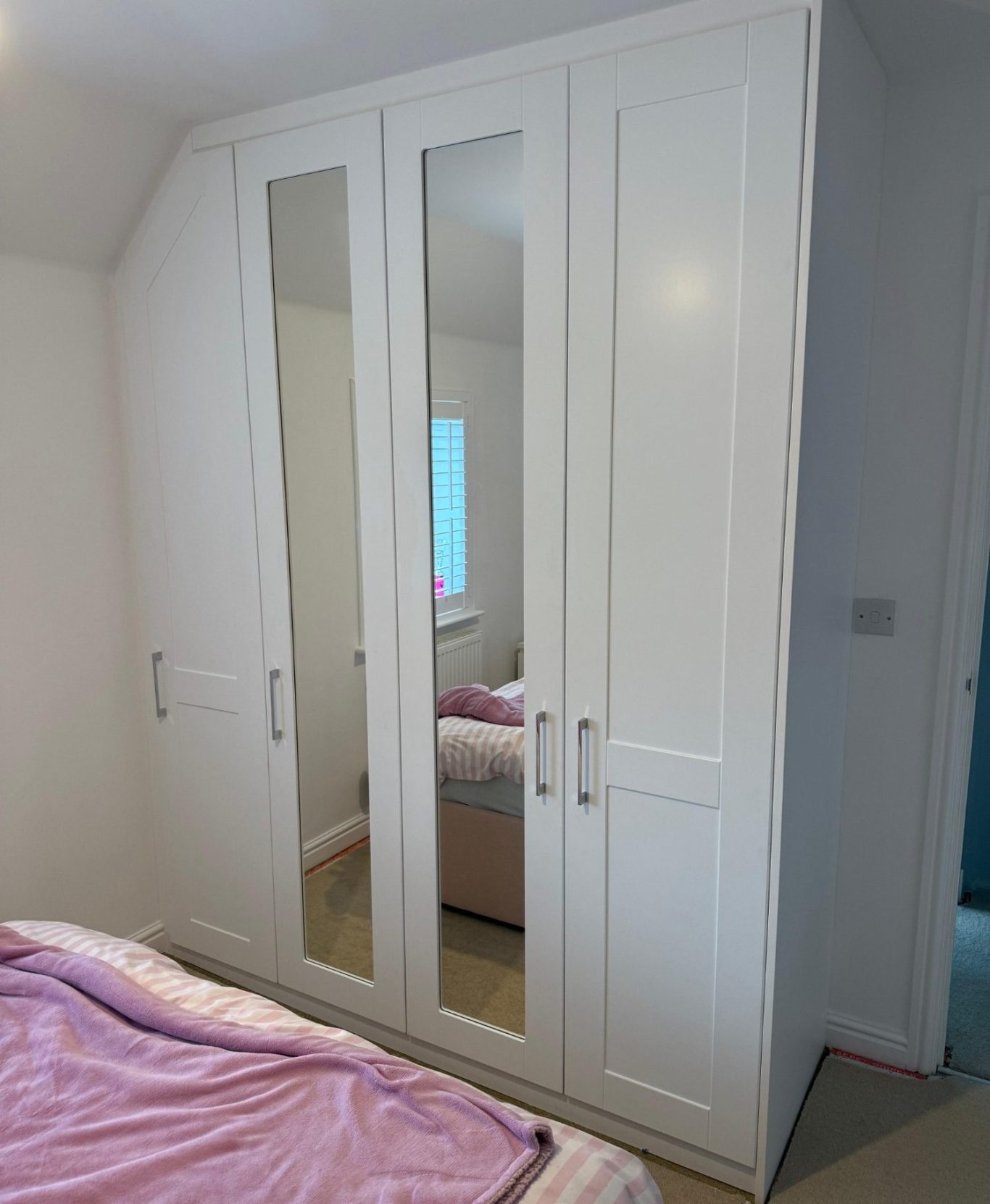 bespoke fitted angled wardrobe with shaker style doors. Bespoke fitted angled hinged wardrobe in Chatham, Kent.