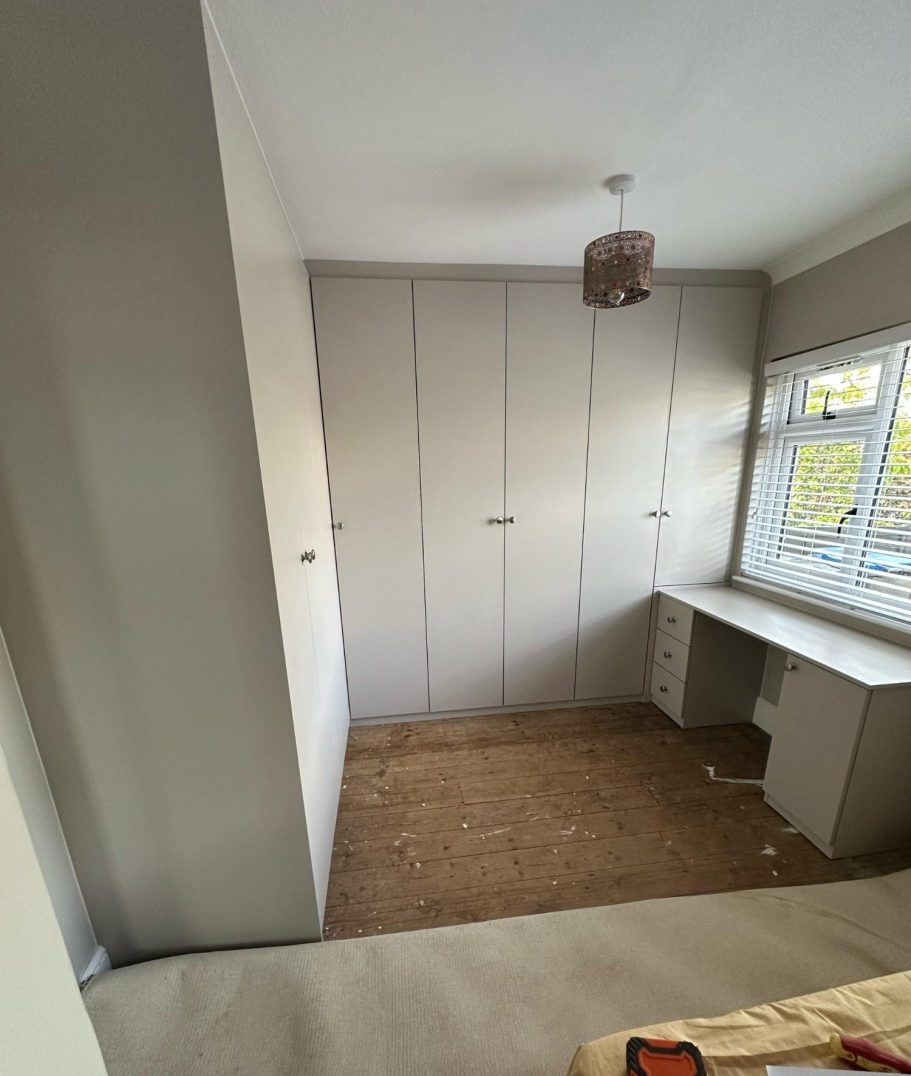 Corner hinged wardrobe with fitted dressing table Bespoke fitted corner wardrobe with fitted dressing table in Chatham, Kent.