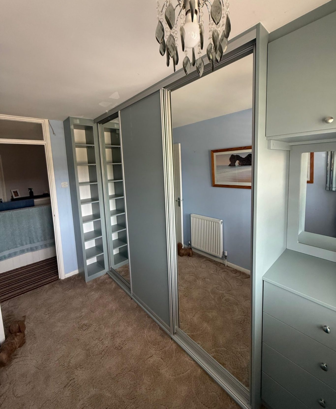 Made to measure, bespoke fitted 3 door sliding wardrobe with fitted dressing table area and vinyl framed mirror in Kent.